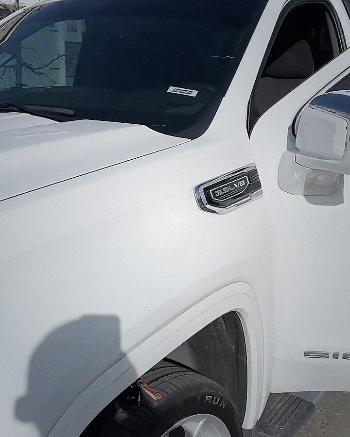 White GMC Sierra windshield replaced in the customer's driveway