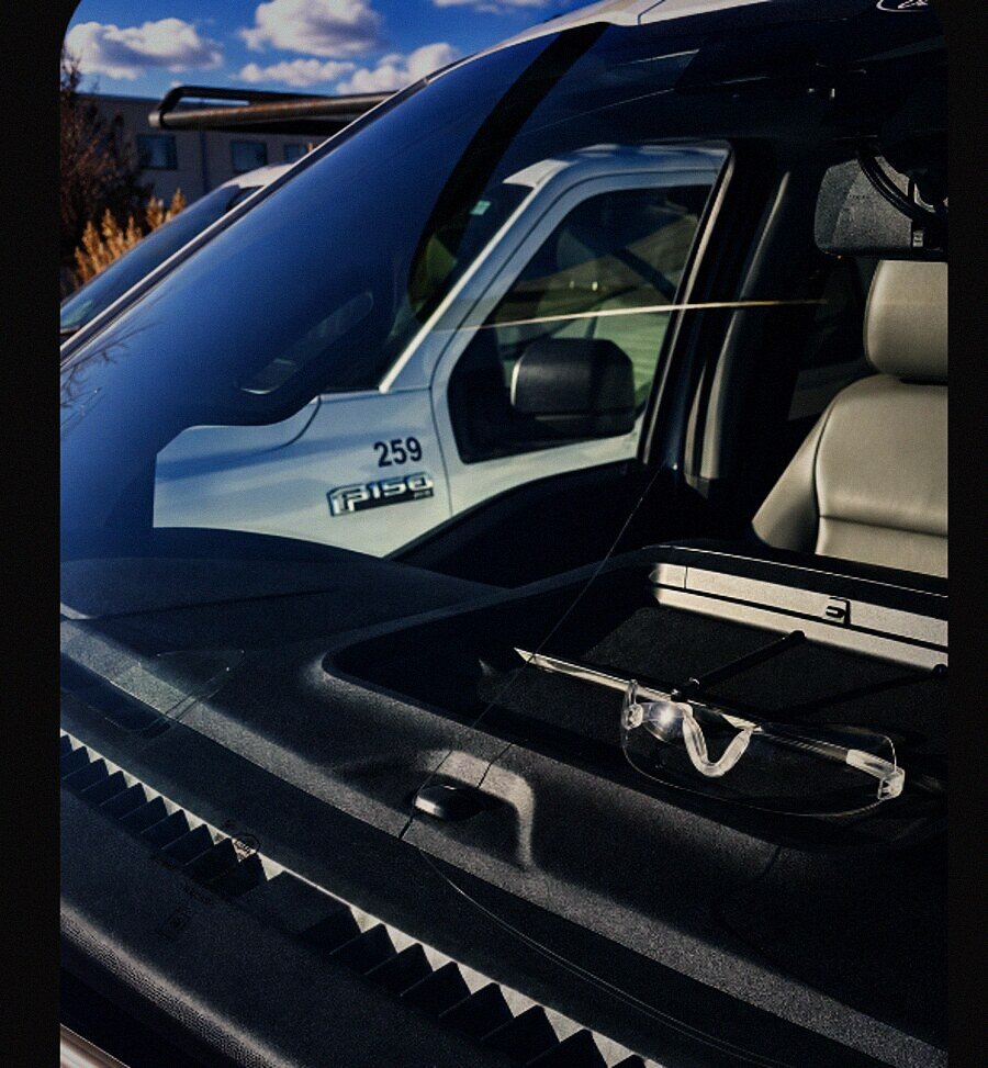 New windshield on a Ford F-150, safety glasses on the cowl