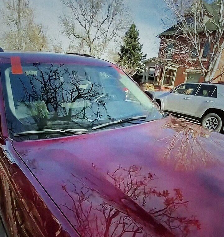 Fresh windshield with retention tape on a minivan